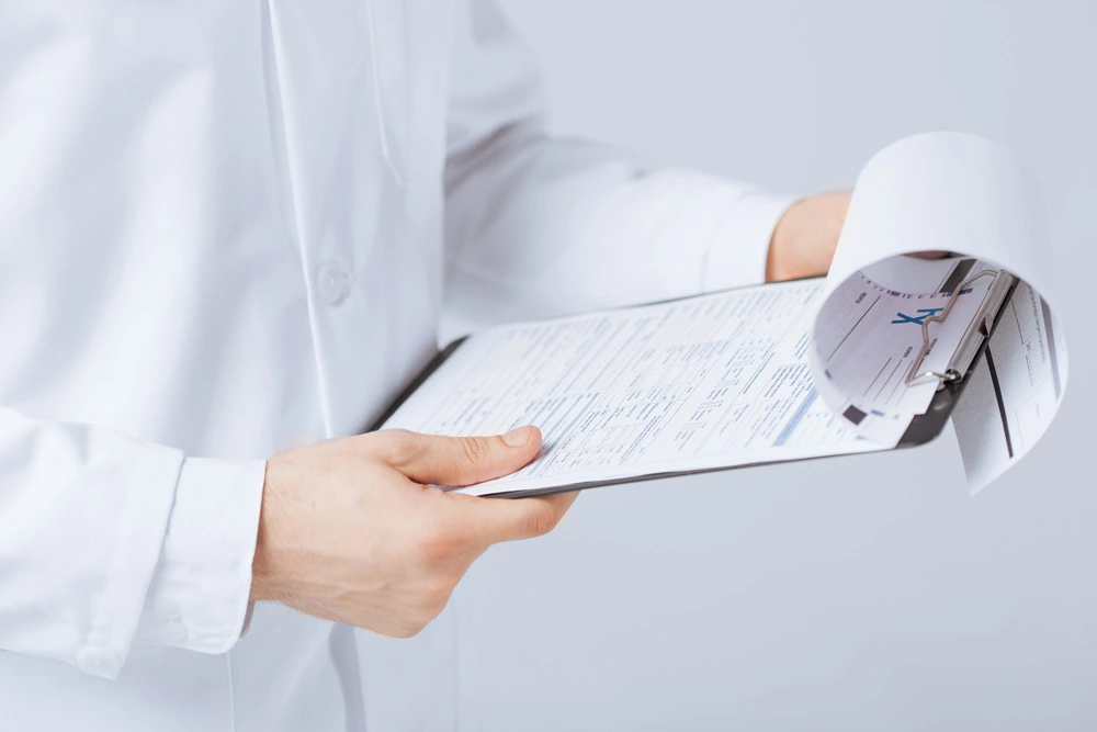 pharmacist checking records on clipboard