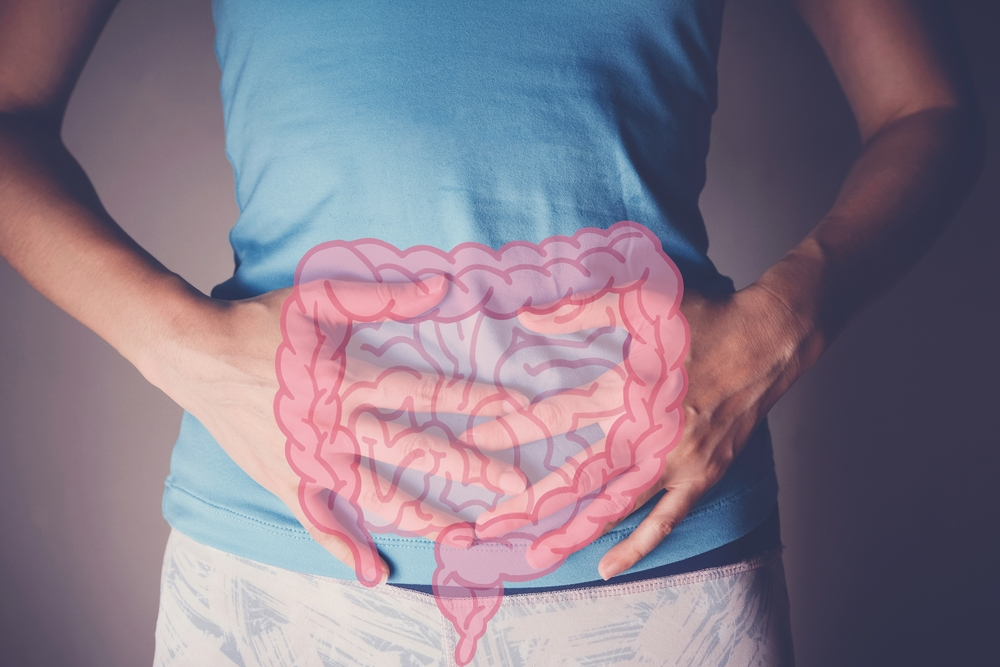 holding stomach with illustration of gut