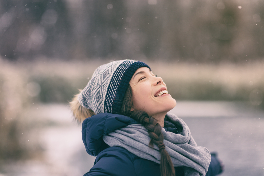 woman smiling in snowfall