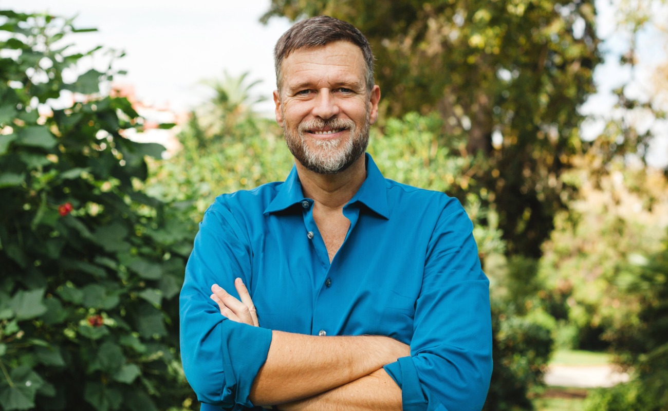 Confident middle-aged man standing outside.